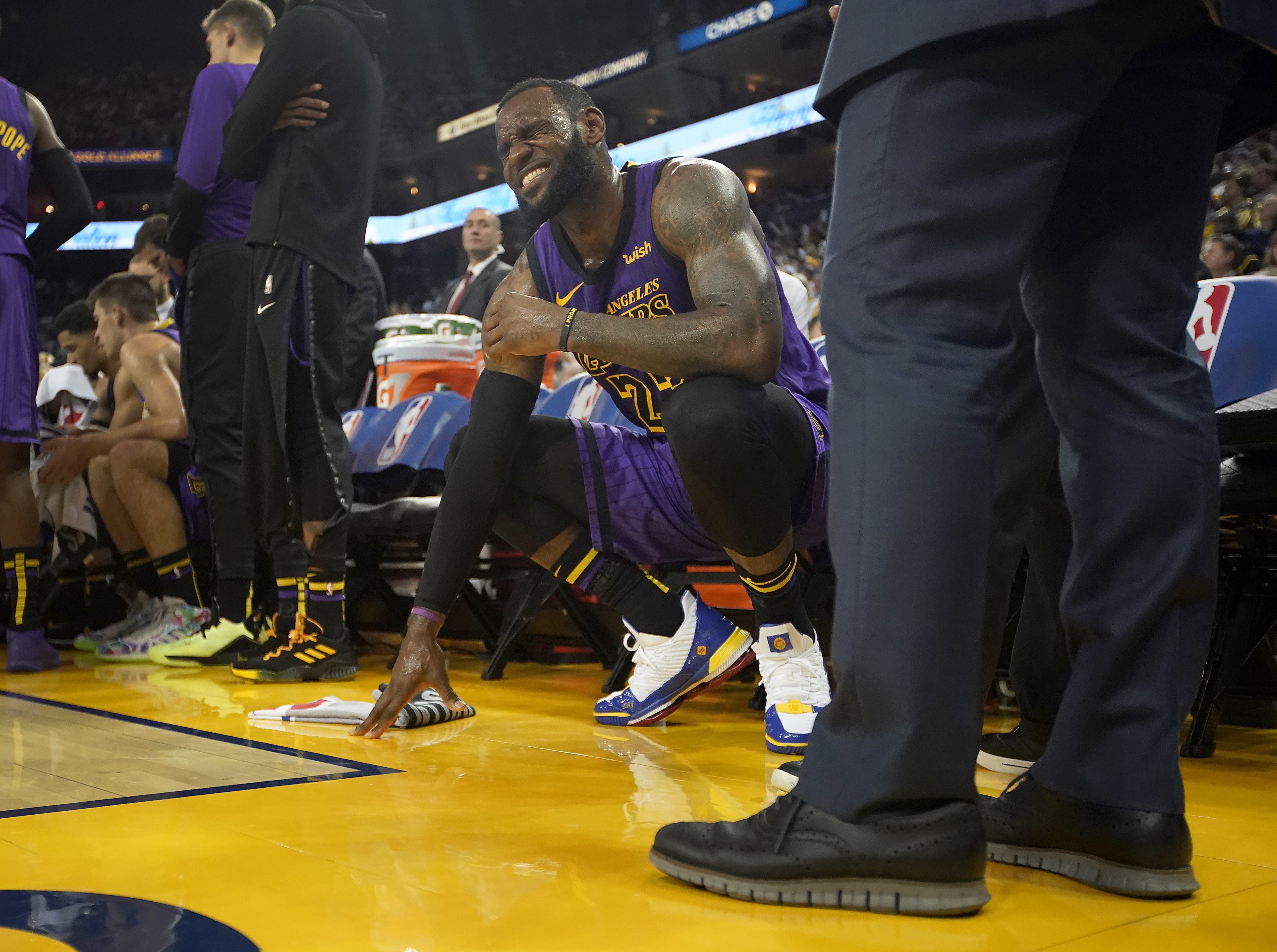 Los Angeles Lakers forward LeBron James (23) grimaces after straining his left groin, during the second half of the team's NBA basketball game against the Golden State Warriors on Tuesday, Dec. 25, 2018, in Oakland, Calif. The Lakers won 127-101.
