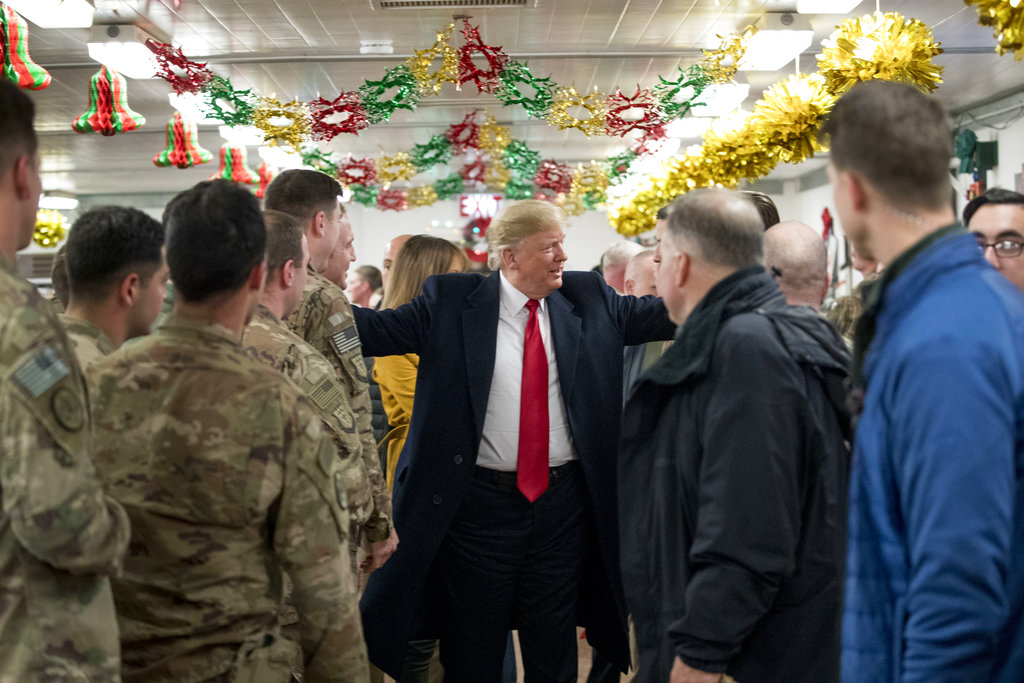 President Donald Trump visits with members of the military at a dining hall at Al Asad Air Base, Iraq, Wednesday, Dec. 26, 2018.