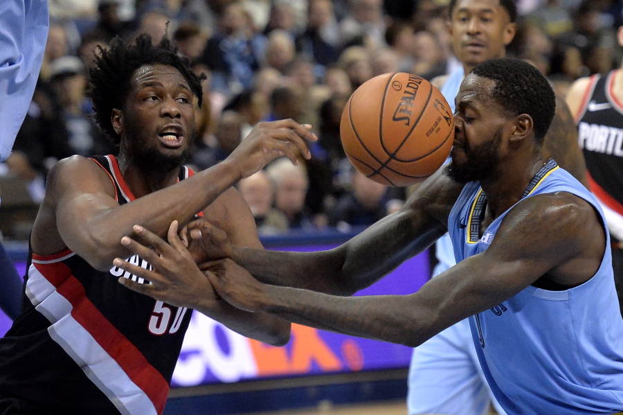 Portland Trail Blazers forward Caleb Swanigan (50) and Memphis Grizzlies forward JaMychal Green, right, struggle for control of the ball in the second half of an NBA basketball game on Wednesday, Dec. 12, 2018, in Memphis, Tenn.