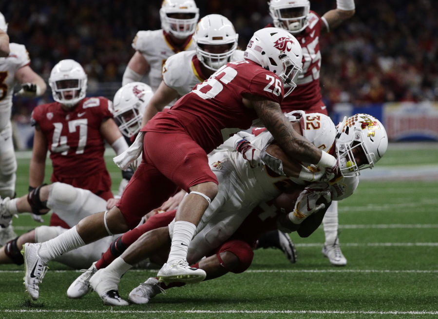 Iowa State running back David Montgomery (32) is hit by Washington State defensive back Hunter Dale (26) and another defender, partially obscure, during the second half of the Alamo Bowl NCAA college football game Friday, Dec. 28, 2018, in San Antonio.
