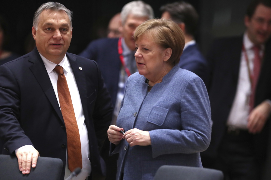 German Chancellor Angela Merkel, right, speaks with Hungarian Prime Minister Viktor Orban during a round table meeting at an EU summit in Brussels on Friday. European Union leaders have offered Theresa May sympathy but no promises, as the British prime minister seeks a lifeline that could help her sell her Brexit divorce deal to a hostile U.K. Parliament.
