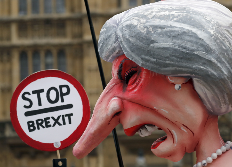 A sculpture depicting Britain’s Prime Minister Theresa May stands opposite Parliament as the protest against Brexit continuous in London, Wednesday.