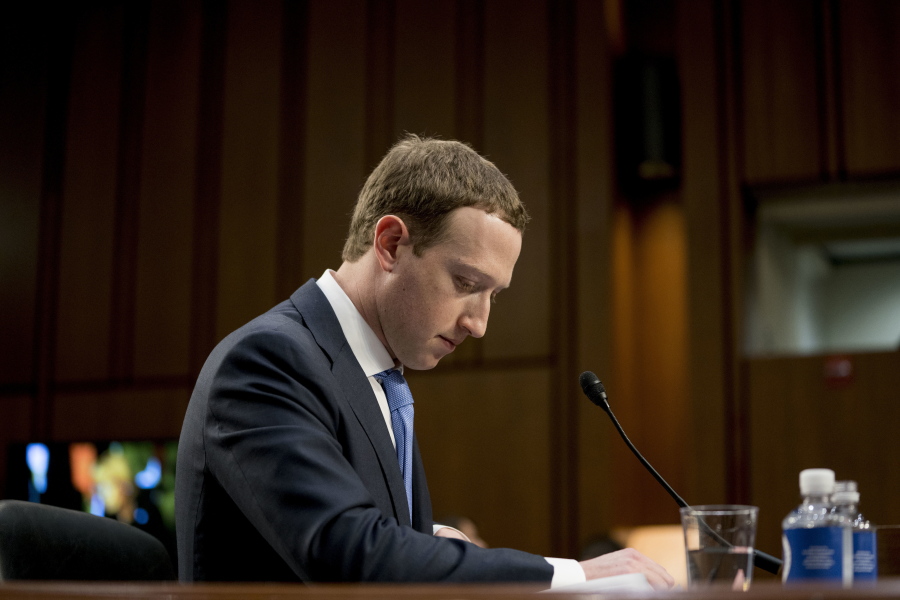FILE- In this April 10, 2018, file photo Facebook CEO Mark Zuckerberg pauses while testifying before a joint hearing of the Commerce and Judiciary Committees on Capitol Hill in Washington about the use of Facebook data to target American voters in the 2016 election. The British Parliament has released some 250 pages worth of documents that show Facebook considered charging developers for data access. The documents show internal discussions about linking data to revenue.