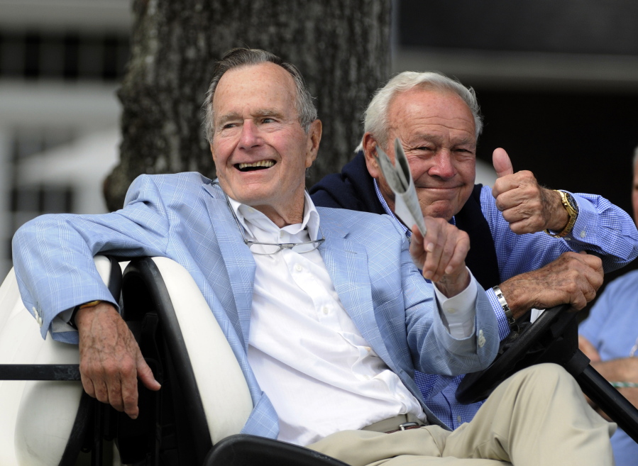 Former President George H. W. Bush and golfing great Arnold Palmer at the Champions Tour golf tournament on Oct. 22, 2010, in The Woodlands, Texas. Bush, who died Friday, Nov. 30, 2018, was one of two presidents inducted into the World Golf Hall of Fame.
