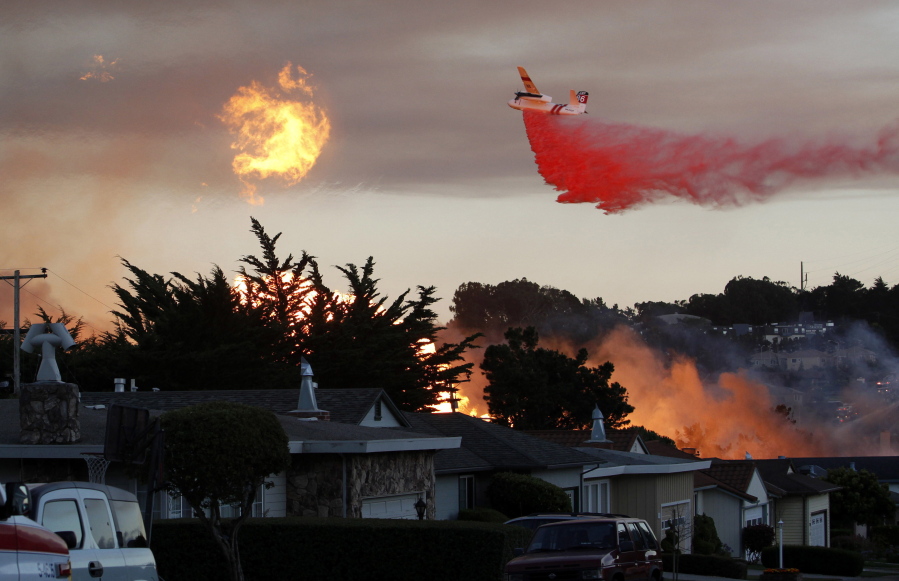 FILE - In this Sept. 9, 2010, file photo, a massive fire following a pipeline explosion roars through a mostly residential neighborhood in San Bruno, Calif. The California Public Utilities Commission said Friday, Dec. 14, 2018, that an investigation by its staff found Pacific Gas & Electric Co. lacked enough employees to fulfill requests to find and mark natural gas pipelines. A U.S. judge fined the utility $3 million after it was convicted of six felony charges for failing to properly maintain a natural gas pipeline that exploded south of San Francisco in 2010, killing eight people.