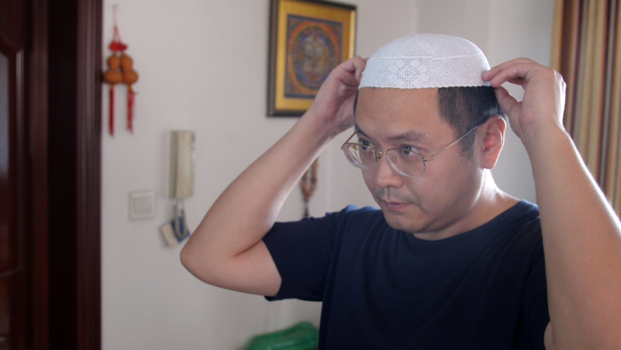 Muslim Chinese poet Cui Haoxin dons an Islamic hat in his home in the city of Jinan in the eastern province of Shandong, China. Cui is an outspoken critic of the government’s policies towards Muslims at home and abroad, writing poetry and tweeting about alleged abuses against Islamic traditions.