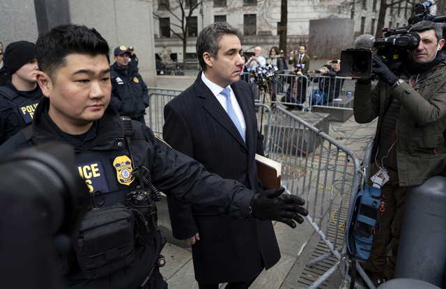 In this Dec. 12, 2018, photo, Michael Cohen, President Donald Trump's former lawyer, leaves federal court after his sentencing in New York. Trump has gone from denying knowledge of any payments to women who claim to have been mistresses to apparent acknowledgement of those hush money settlements – though he claims they wouldn't be illegal.