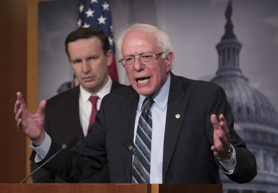 Sen. Bernie Sanders, I-Vt., joined at left by Sen. Chris Murphy, D-Conn., holds a news conference after the Senate passed a resolution he introduced that would pull assistance from the Saudi-led war in Yemen, a measure to rebuke Saudi Arabia after the killing of journalist Jamal Khashoggi, at the Capitol in Washington, Thursday, Dec. 13, 2018. (AP Photo/J.