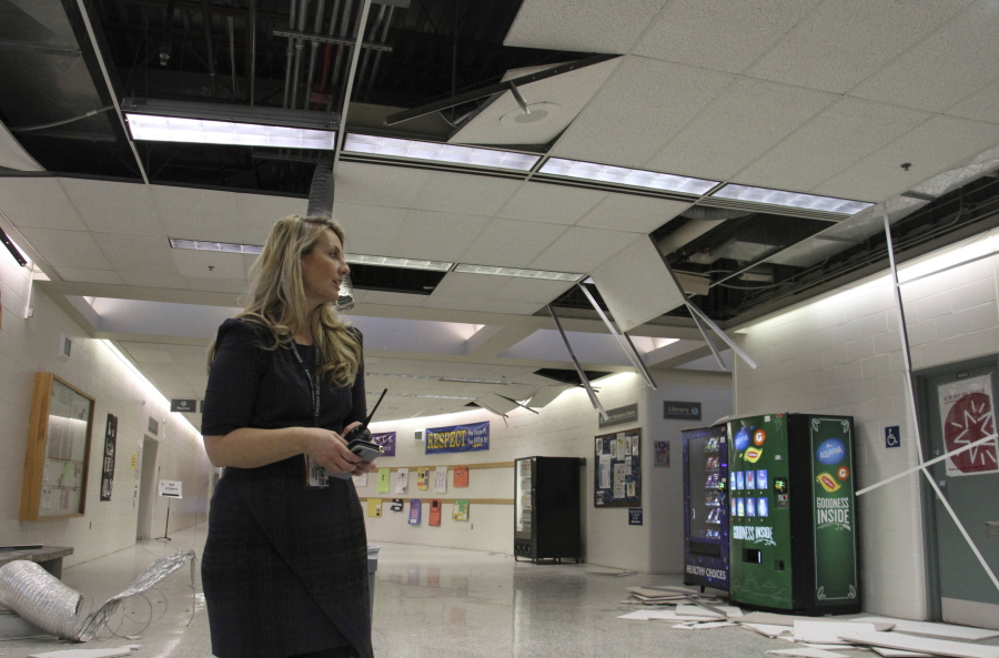 Allison Susel, acting principal at Chugiak High School in Chugiak, Alaska, surveys damage following Friday’s magnitude 7.0 earthquake. She said ceiling tiles came down, items were thrown off shelves and there was water damage, but there were no injuries to students or staff at the suburban Anchorage school.