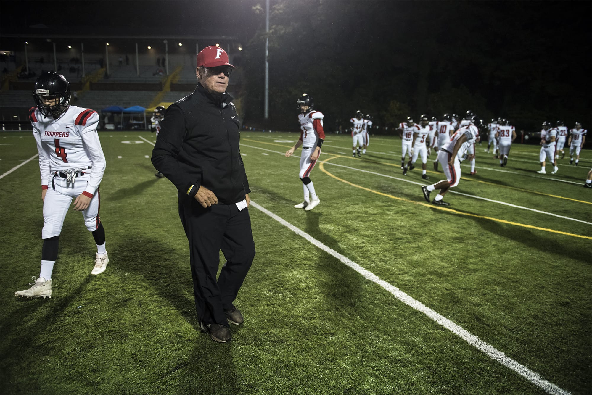 Neil Lomax, Fort Vancouver head coach, runs warm ups before a game in the Kiggins Bowl on Friday night, Oct.