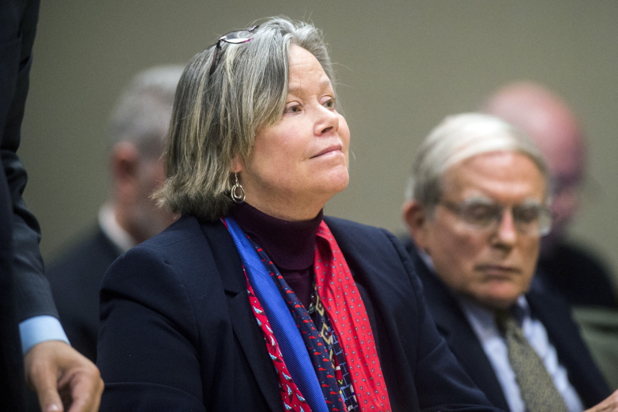 Dr. Eden Wells listens as Genesee District Judge William Crawford reads through a prepared statement during a hearing Friday, Dec. 7, 2018, at Genesee District Court in downtown Flint, Mich. Wells, Michigan’s chief medical executive, will stand trial on involuntary manslaughter and other charges in a criminal investigation of the Flint water crisis, a judge ruled Friday.