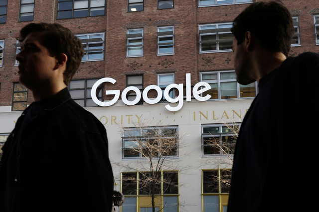 In this Dec. 4, 2017, file photo, people walk by Google offices in New York. Google is spending more than $1 billion to expand operations in New York City. Ruth Porat, senior vice president and chief financial officer at Google and Alphabet, said in a blog post Monday, Dec. 17, 2018, that Google is creating a more than 1.7 million square-foot campus that includes lease agreements along the Hudson River in lower Manhattan.