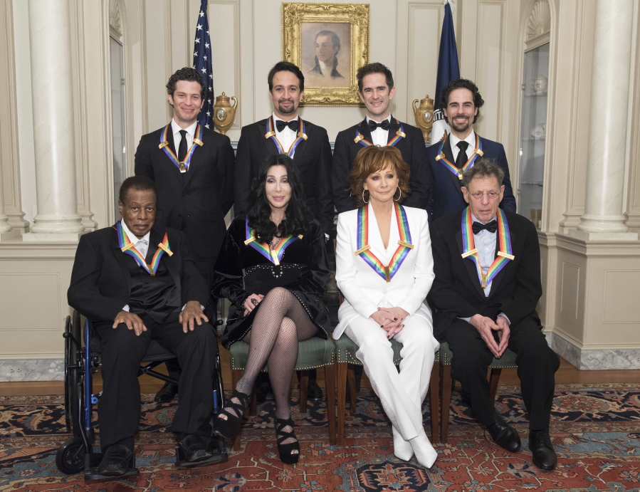2018 Kennedy Center honorees, front row from left, Wayne Shorter, Cher, Reba McEntire, Philip Glass, back row from left, the co-creators of “Hamilton,” Thomas Kail, Lin-Manuel Miranda, Andy Blankenbuehler, Alex Lacamoire pose at the State Department on Saturday in Washington.