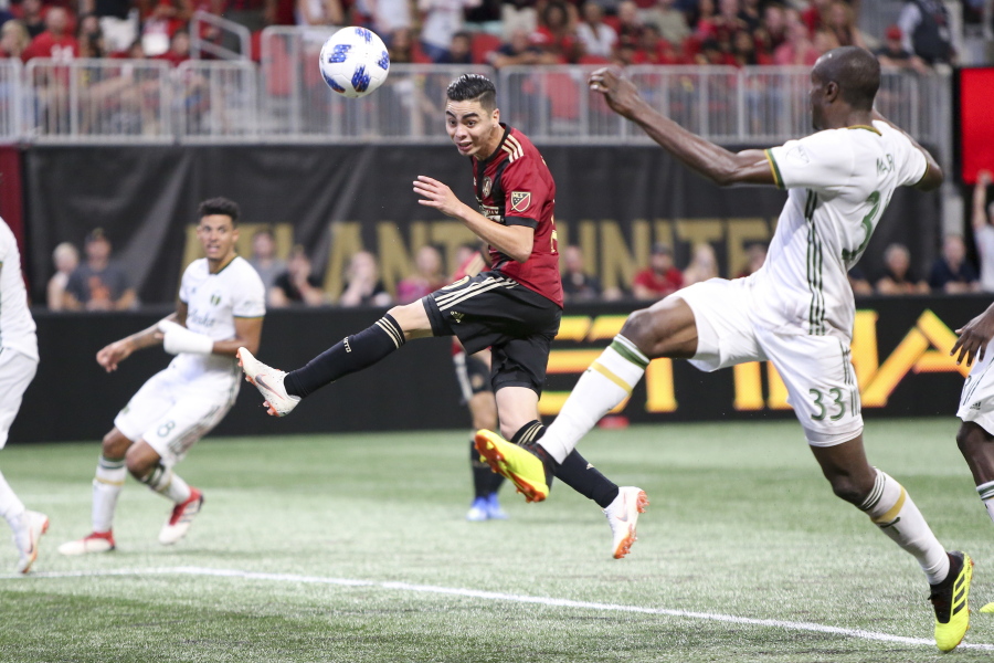 Atlanta United midfielder Miguel Almiron (10) has a shot defended by Portland Timbers defender Larrys Mabiala (33) in the second half of an MLS match on June 24, 2018 at Atlanta. Before an expected crowd of more than 70,000, Atlanta United will host the Portland Timbers in the MLS Cup championship game Saturday, Dec. 8, 2018.