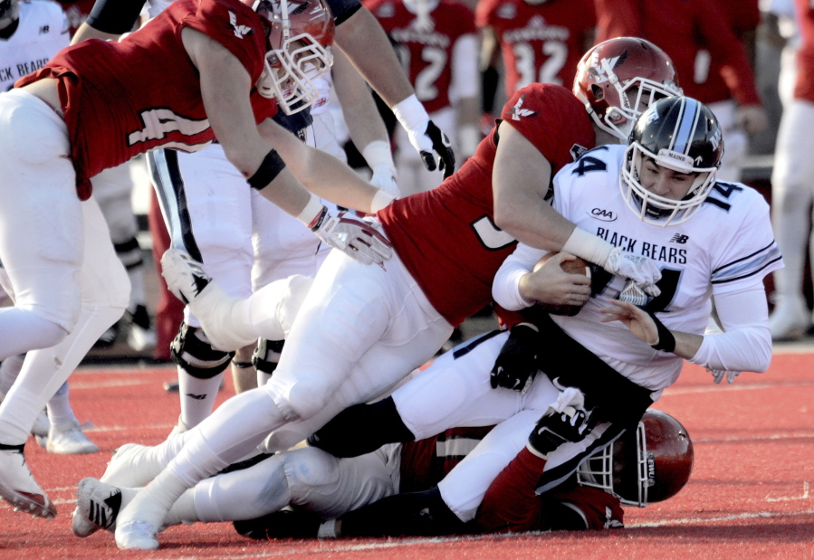 Eastern Washington Eagles Mitchell Johnson (94) and Jonah Jordan (91) sack Maine’s quarterback Chris Ferguson during the first half of a college football game on Saturday, Dec.15, 2018, in Cheney, Wash.