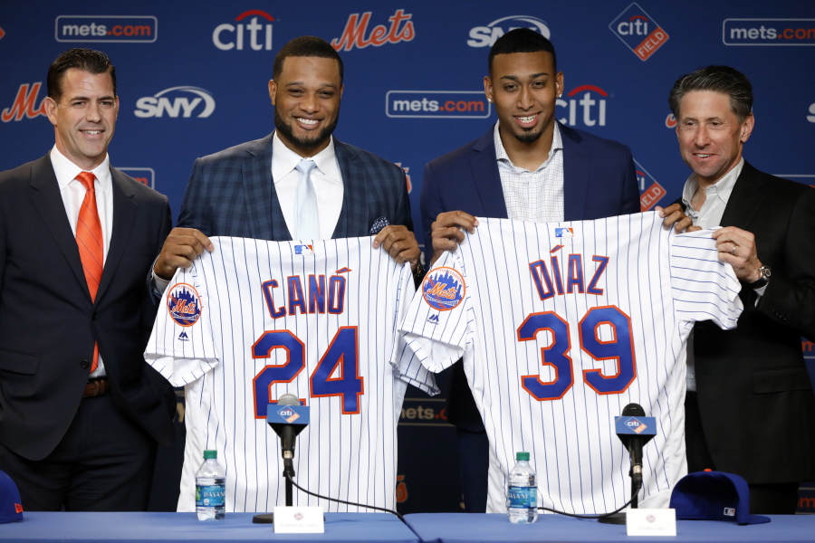 New York Mets’ Robinson Cano, second left, and Edwin Díaz, third left, pose with their new jerseys as they are introduced at a news conference at CitiField, in New York, Tuesday, Dec. 4, 2018. The Mets acquired eight-time All-Star second baseman Robinson Cano and major league saves leader Edwin Diaz from the Seattle Mariners in a seven-player trade Monday. They are joined by New York Mets General Manger Brodie Van Wagenen, left, and team COO Jeff Wilpon.