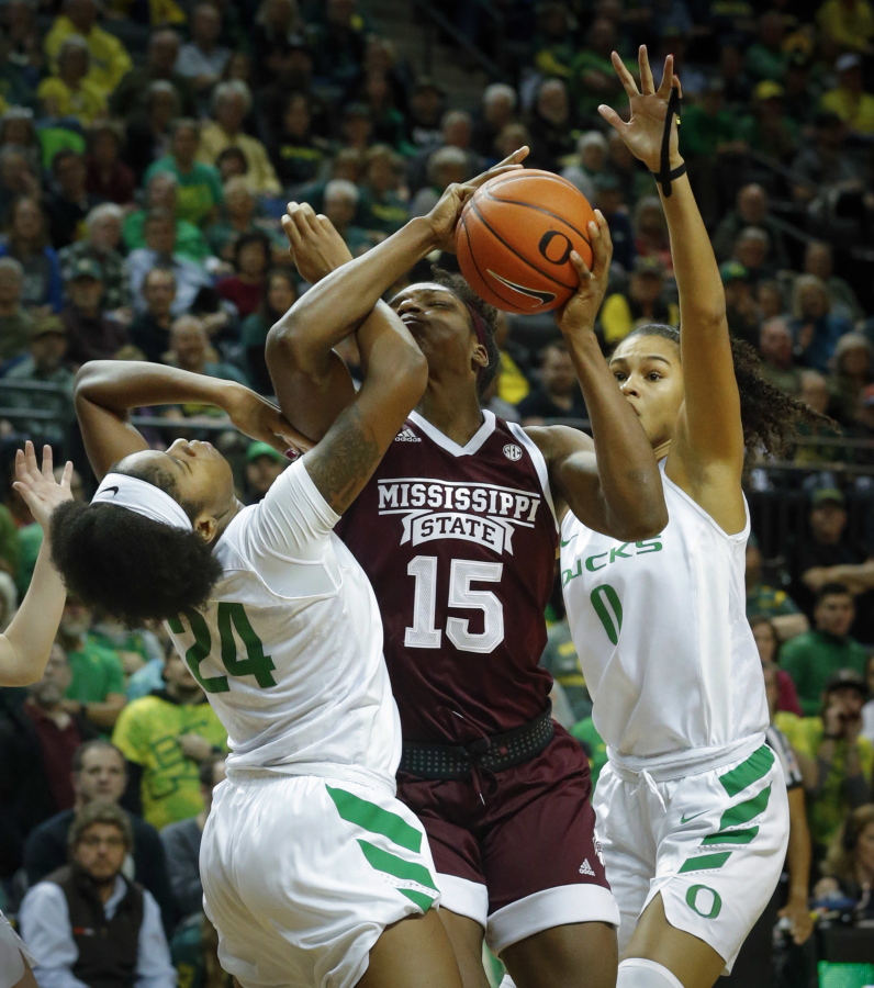 Oregon forward Ruthy Hebard is fouled by Mississippi State center Teaira McCowan as Oregon forward Satou Sabally helps out on the play in the second quarter of a women’s college basketball game Tuesday, Dec. 18, 2018, in Eugene, Ore. No. 7 Oregon defeated No. 4 Mississippi State 82-74.