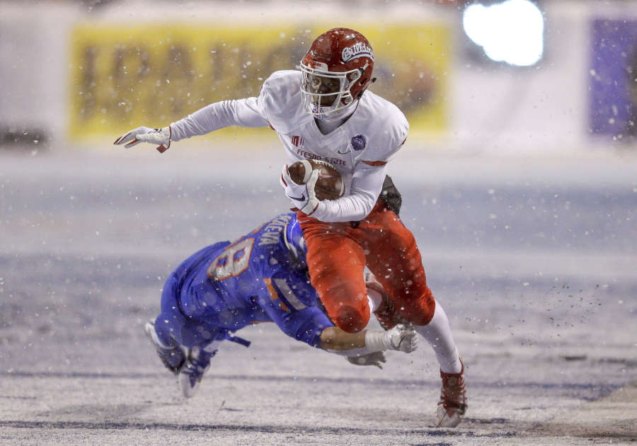 Fresno State wide receiver Derrion Grim (7) is tripped up by Boise State linebacker Tyson Maeva (58) after a reception during the first half of an NCAA college football game for the Mountain West championship Saturday, Dec. 1, 2018, in Boise, Idaho.
