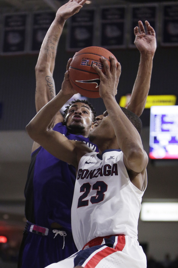 Gonzaga guard Zach Norvell Jr. (23) shoots while defended by North Alabama forward Emanuel Littles during the second half of an NCAA college basketball game in Spokane, Wash., Friday, Dec. 28, 2018. Gonzaga won 96-51.