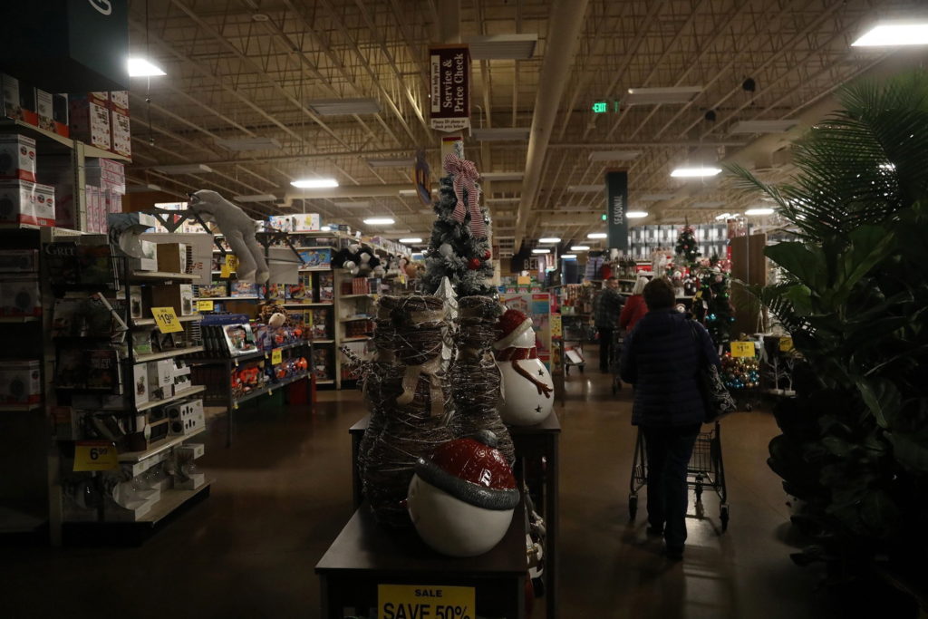 A power outage at the Ballard Fred Meyer forced the store to operate on minimum power Thursday, Dec. 20, 2018, in Seattle, with the aisles in various degrees of darkness. More than 140,000 households and businesses lost power Thursday as strong winds toppled trees, closed roads and even trapped a trampoline between power lines in western Washington.