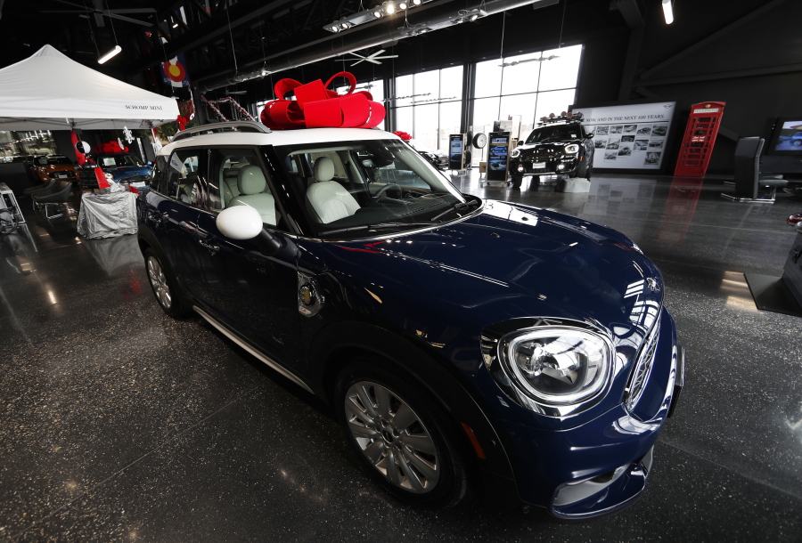 A large red bow to mark the holiday season sits on the roof of an unsold 2019 Countryman on the floor of a Mini dealership in Highlands Ranch, Colo.