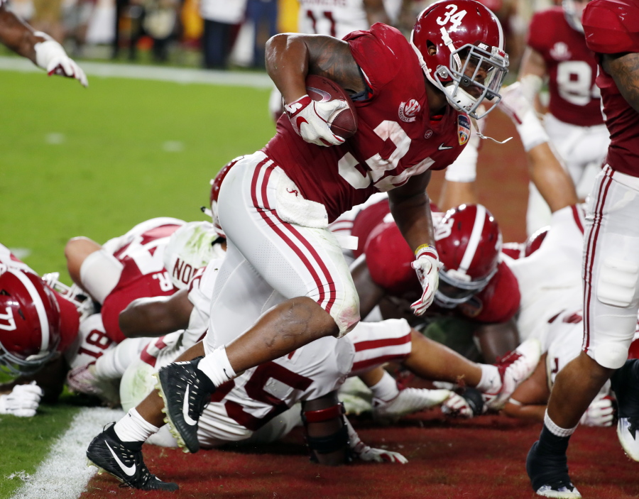 Alabama running back Damien Harris (34) scores a touchdown, during the first half of the Orange Bowl NCAA college football game against Oklahoma, Saturday, Dec. 29, 2018, in Miami Gardens, Fla.