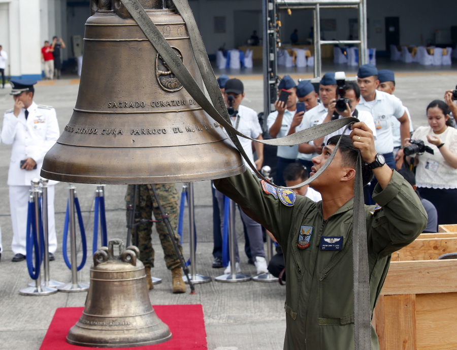 Philippine Air Force personnel unload three church bells seized by American troops as war trophies more than a century ago, as they arrive Tuesday in suburban Pasay city、 southeast of Manila, Philippines. American occupation troops took the bells in 1901 from a Catholic church following an attack by machete-wielding Filipino villagers, who killed 48 U.S. troops in the town of Balangiga on central Samar island in one of the U.S. Army’s worst single-battle losses of that era. The bells are revered by Filipinos as symbols of national pride.