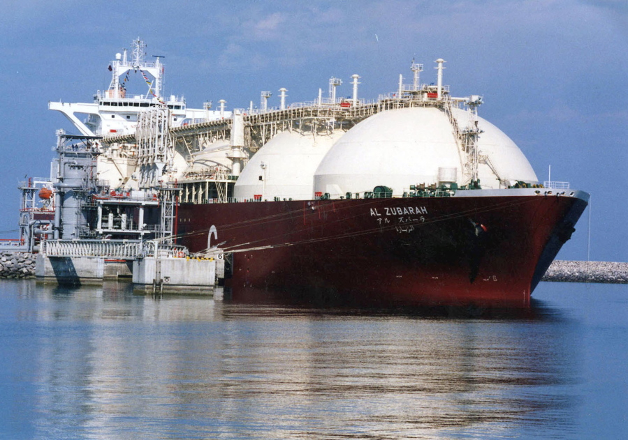 FILE - This undated file photo shows a Qatari liquid natural gas (LNG) tanker ship being loaded up with LNG at Raslaffans Sea Port, northern Qatar. The tiny, energy-rich Arab nation of Qatar announced on Monday, Dec. 3, 2018 it would withdraw from OPEC, mixing its aspirations to increase production outside of the cartel’s constraints with the politics of slighting the Saudi-dominated group amid the kingdom’s boycott of Doha.