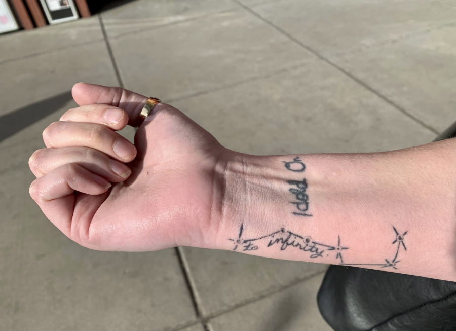 In this Dec. 18, 2018 photo, sexual assault survivor Sam Gaspardo displays her “HOLD ON” and “to infinity” tattoos on her right arm in Minneapolis. The “HOLD ON” tattoo is in her mother’s handwriting. It’s to remind Sam to hold on when she’s struggling.