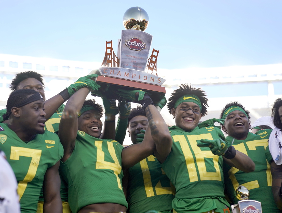 Oregon cornerback Thomas Graham Jr. (4) holds the trophy next to teammates after a 7-6 win over Michigan State during the Redbox Bowl NCAA college football game Monday, Dec. 31, 2018, in Santa Clara, Calif.