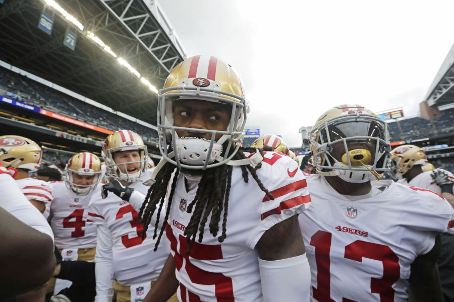 San Francisco 49ers cornerback Richard Sherman, center, huddles with teammates before playing against the Seattle Seahawks, in Seattle. The rematch between the Seahawks and 49ers is on Sunday, Dec. 16.