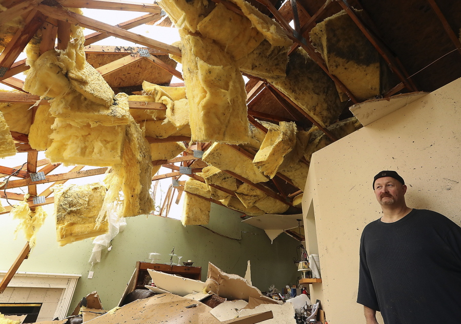 Aaron Crain pauses Dec. 19 as he talks about riding out a tornado in the living room of his heavily damaged home in Port Orchard. The National Weather Service says preliminary investigation shows the tornado that touched down Dec. 18 was rated an EF2. Meegan M.