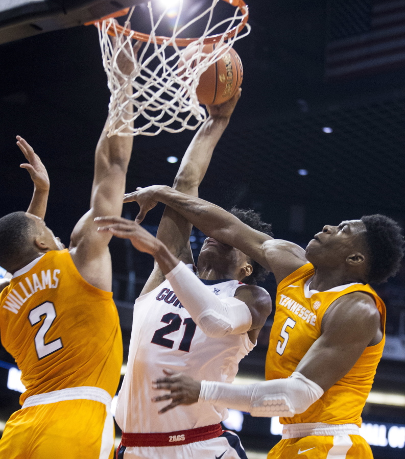 Gonzaga’s Rui Hachimura (21) is fouled by Tennessee’s Admiral Schofield (5) and Grant Williams (2) during the first half of an NCAA college basketball game Sunday, Dec. 9, 2018, in Phoenix.