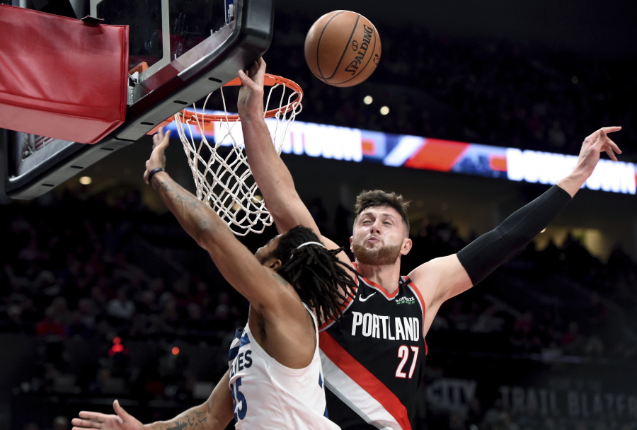 Portland Trail Blazers center Jusuf Nurkic, right, blocks the shot of Minnesota Timberwolves guard Derrick Rose during the first half of an NBA basketball game in Portland, Ore., Saturday, Dec. 8, 2018.