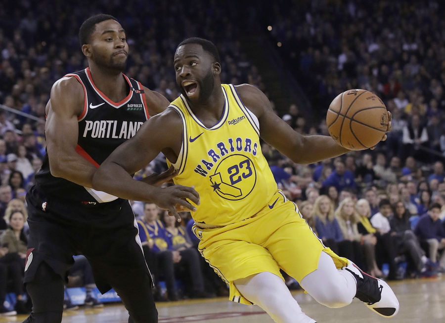 Golden State Warriors forward Draymond Green (23) drives to the basket against Portland Trail Blazers forward Maurice Harkless during the first half of an NBA basketball game in Oakland, Calif., Thursday, Dec. 27, 2018.