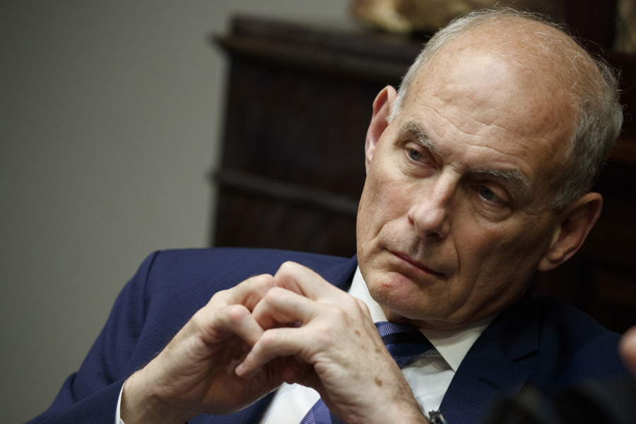In this June 21, 2018 photo, White House chief of staff John Kelly listens as President Donald Trump speaks during a lunch with governors in the Roosevelt Room of the White House in Washington.