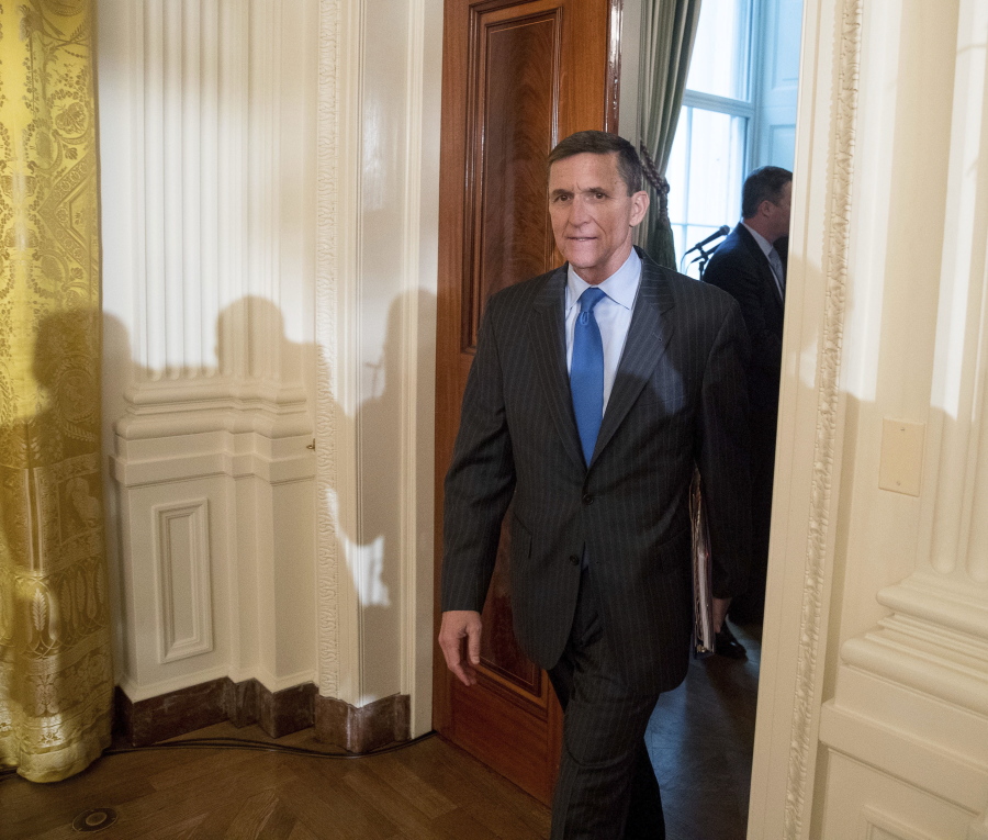 FILE - In this Jan. 22, 2017 file photo, National Security Adviser Michael Flynn arrives for a White House senior staff swearing in ceremony in the East Room of the White House, in Washington. President Donald Trump’s former national security adviser has provided so much information to the special counsel’s Russia investigation that prosecutors say he shouldn’t do any prison time, according to a court filing Tuesday, Dec.