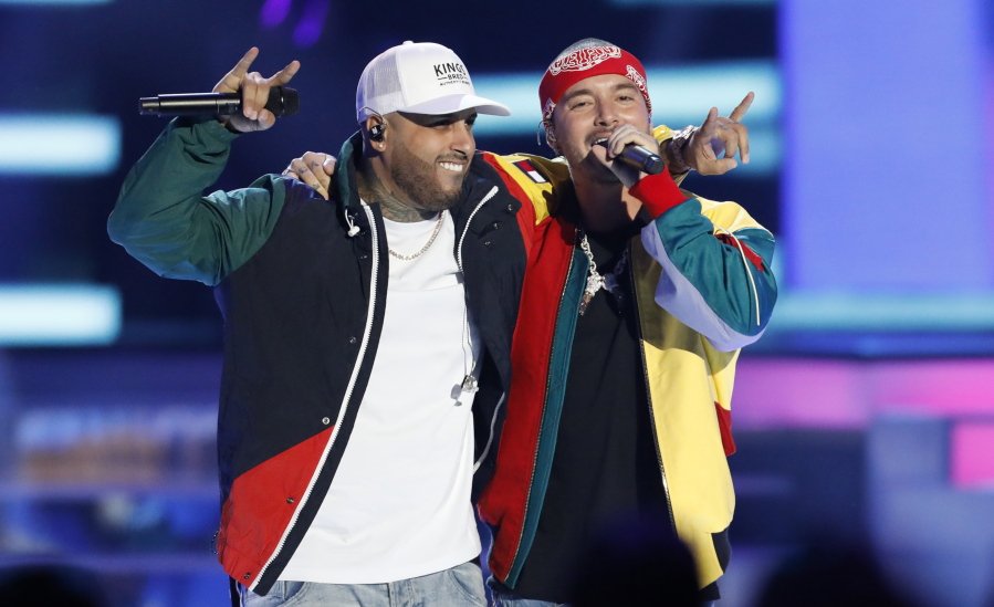 FILE - In this April 26, 2018 file photo, Nicky Jam, left, and J Balvin perform “X (Equis)” at the Billboard Latin Music Awards in Las Vegas. The song is named as one of the top songs of the year by Associated Press Music Editor Mesfin Fekadu.