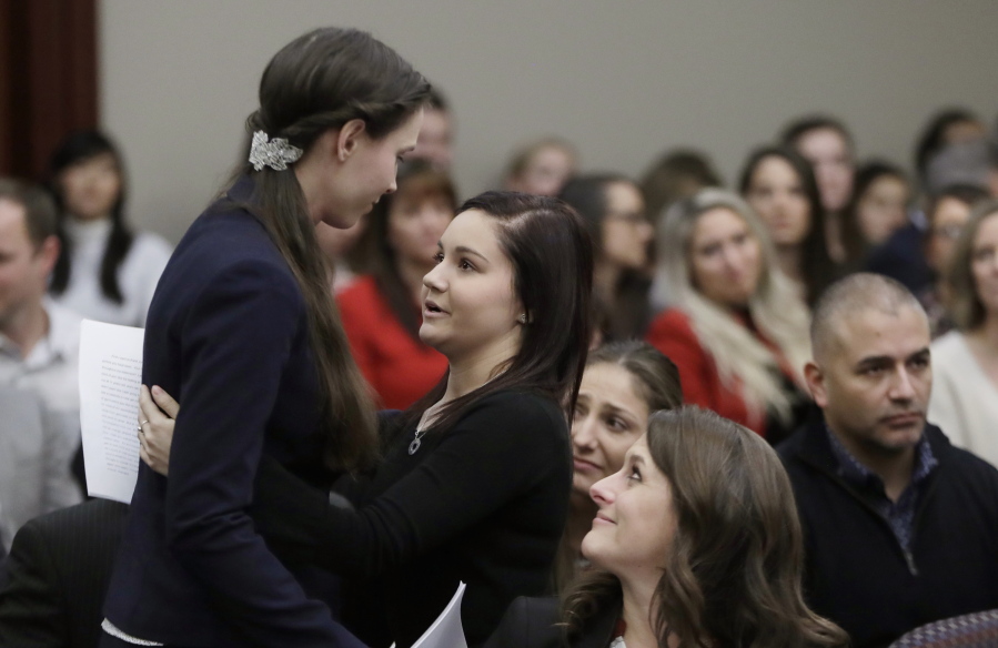 Former gymnast Rachael Denhollander, left, is hugged by Kaylee Lorincz after giving her victim impact statement during the seventh day of Larry Nassar’s sentencing hearing in Lansing, Mich. More than 150 female athletes testified at Nassar’s sentencing hearing in January 2018 for convictions on child-porn and sex-abuse charges. It marked a turning point in a crisis that has inflicted untold damage.