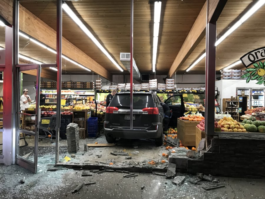 An SUV sits stopped amid what was part of Camas Produce’s fruit selection after its driver, whom the Camas Police Department says was driving while impaired, smashed through the front of the store Thursday evening. No one was injured.