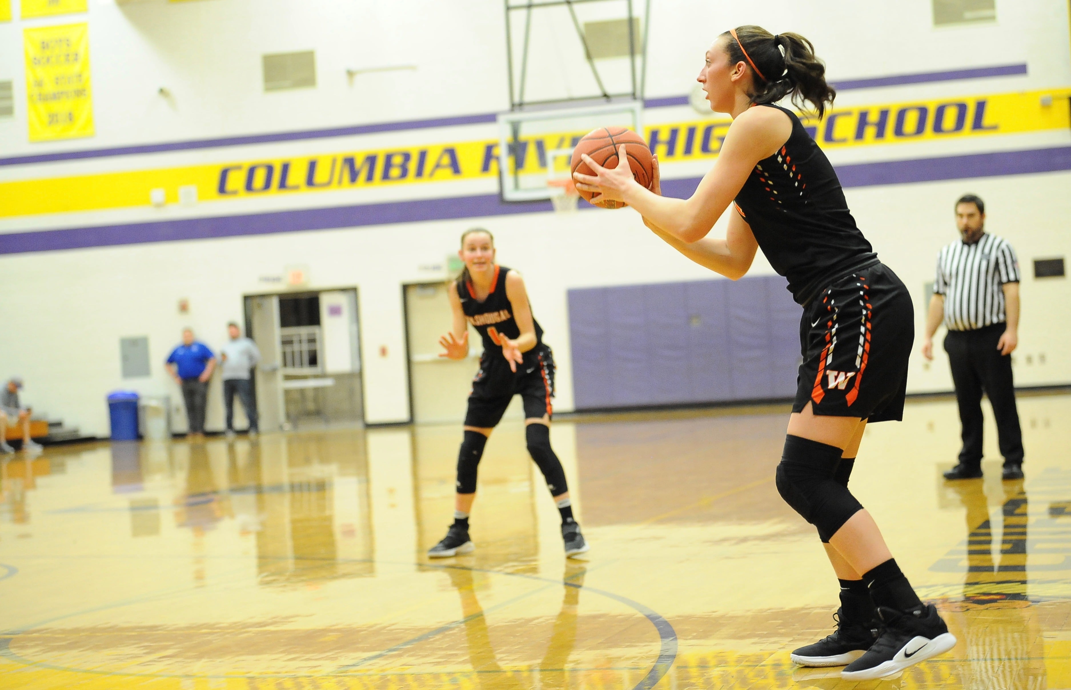 Beyonce Bea (right) readies to shoot a corner 3-pointer as Jaiden Bea (1) beckons to her right during Washougal's 50-41 win over Columbia River on Monday night at Columbia River High School.