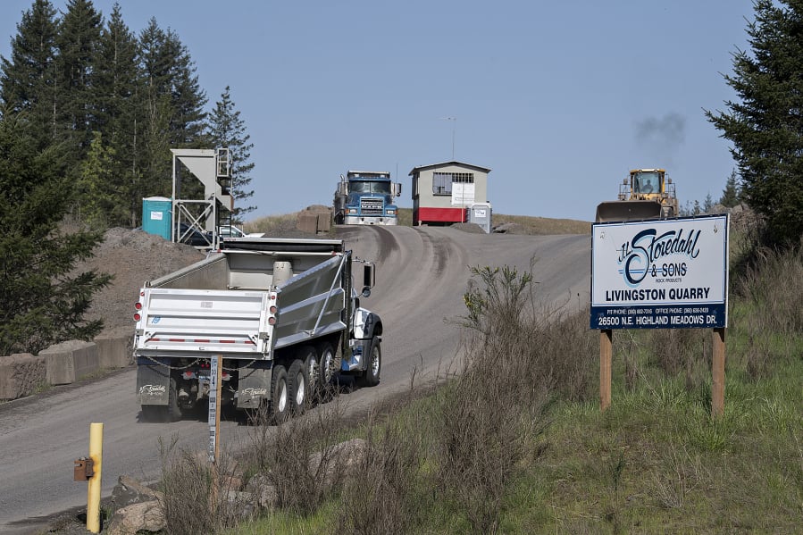 A truck passes a sign for Livingston Mountain Quarry as it enters the facility east of Vancouver on April 26, 2019.