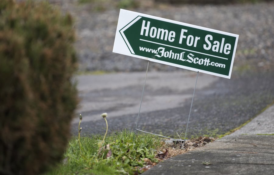 For-sale signs are posted in the Starcrest neighborhood in Vancouver in December.