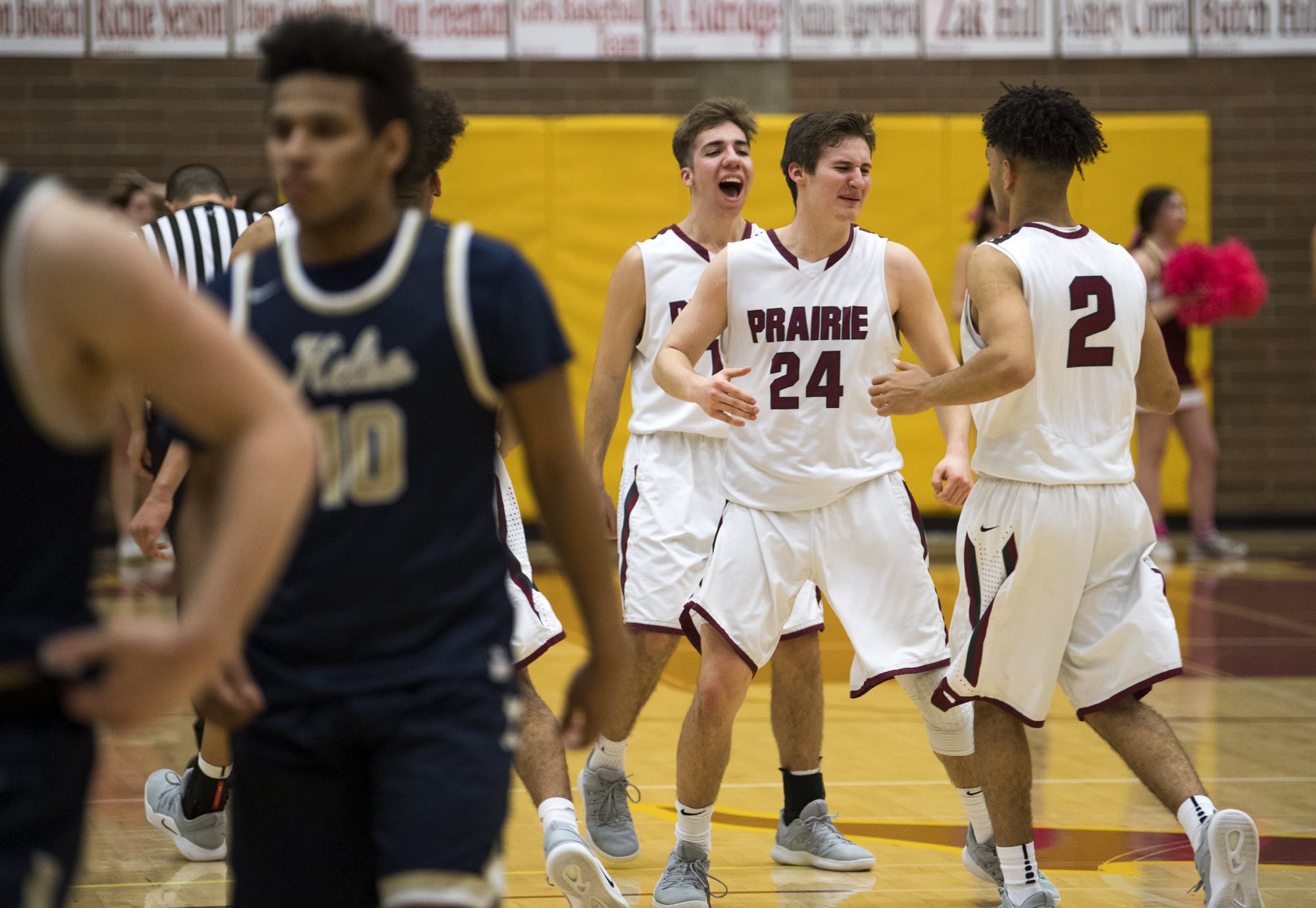Prairie's Thomas Hapgood (10), Bronson King (24) and Aidan Fraly (2) celebrate their win after the game against Kelso in Vancouver on Jan. 22, 2019.