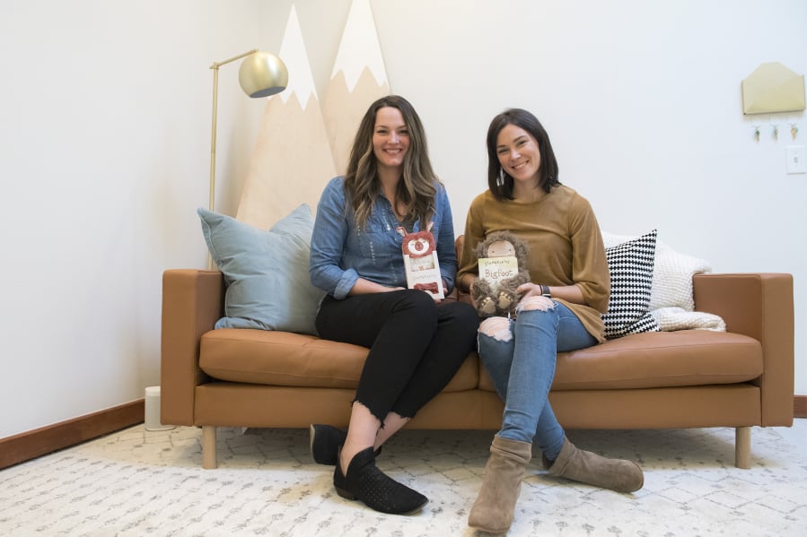 Slumberkins co-founders Callie Christensen, left, and Kelly Oriard sit with two of their plush creations at the Slumberkins offices in downtown Vancouver.