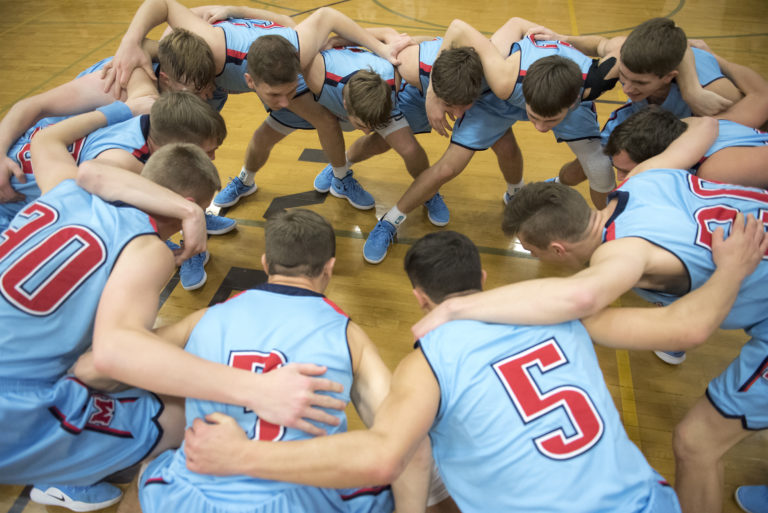 Mark Morris huddles before their match against Columbia River at Columbia River High School on Thursday, Jan. 3, 2019.