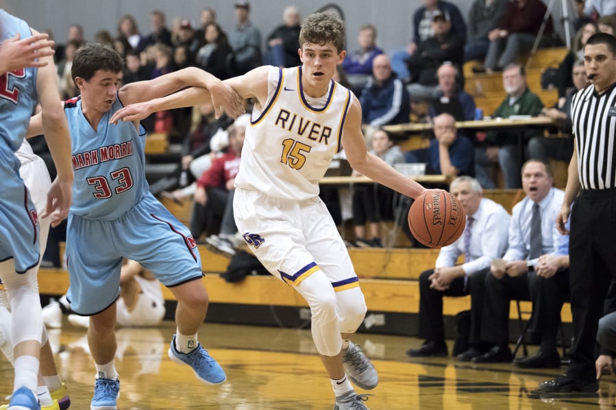 Columbia River’s Evan Dirksen drives through a Mark Morris defender. Dirksen finished with 20 points as River beat the Monarchs 69-50.