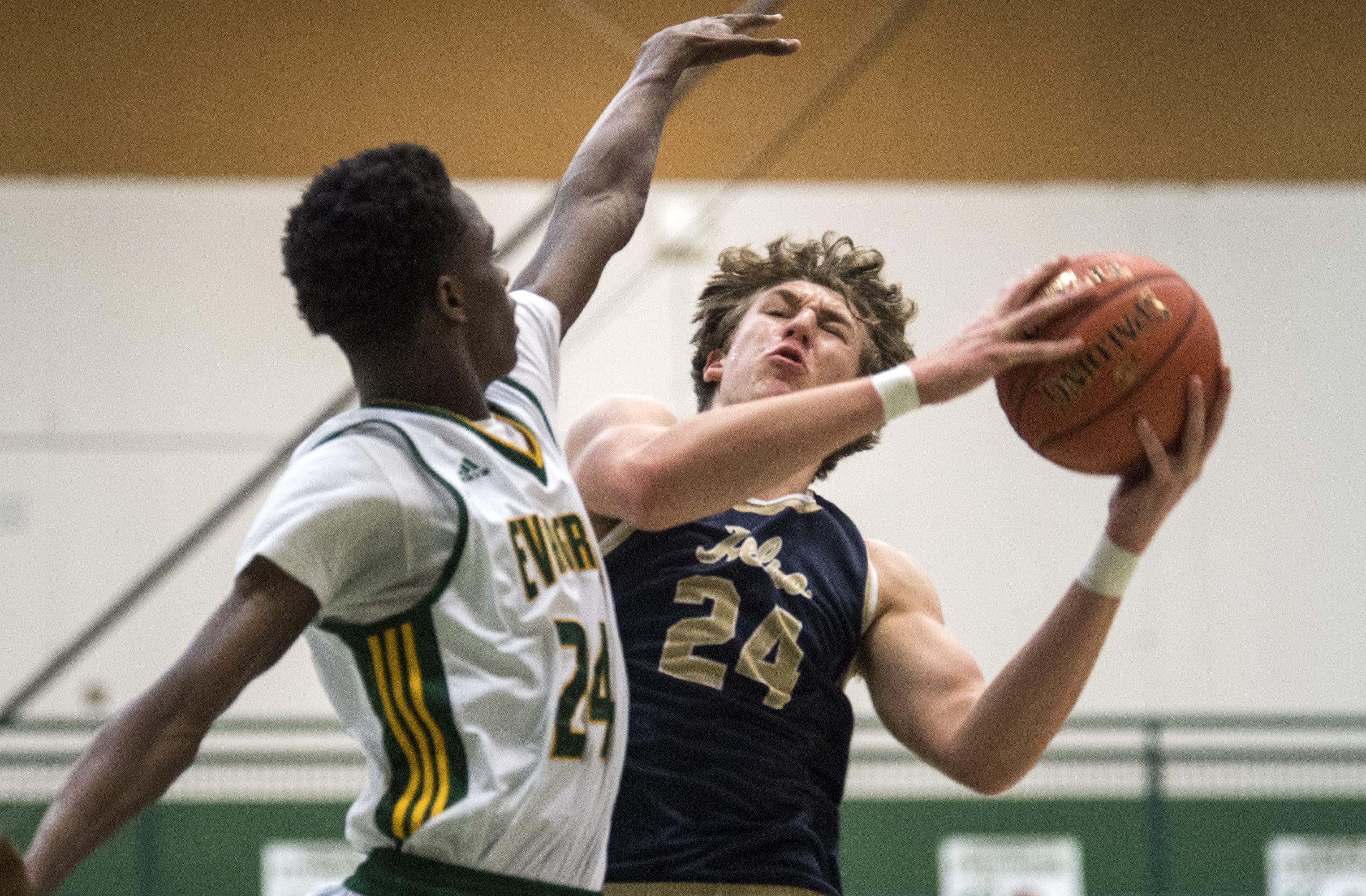Evergreen's Mario Herring (24) jumps to block Kelso's Shaw Anderson (24) during Tuesday night's game at Evergreen High School in Vancouver on Jan. 8, 2019. Kelso won 79-74.