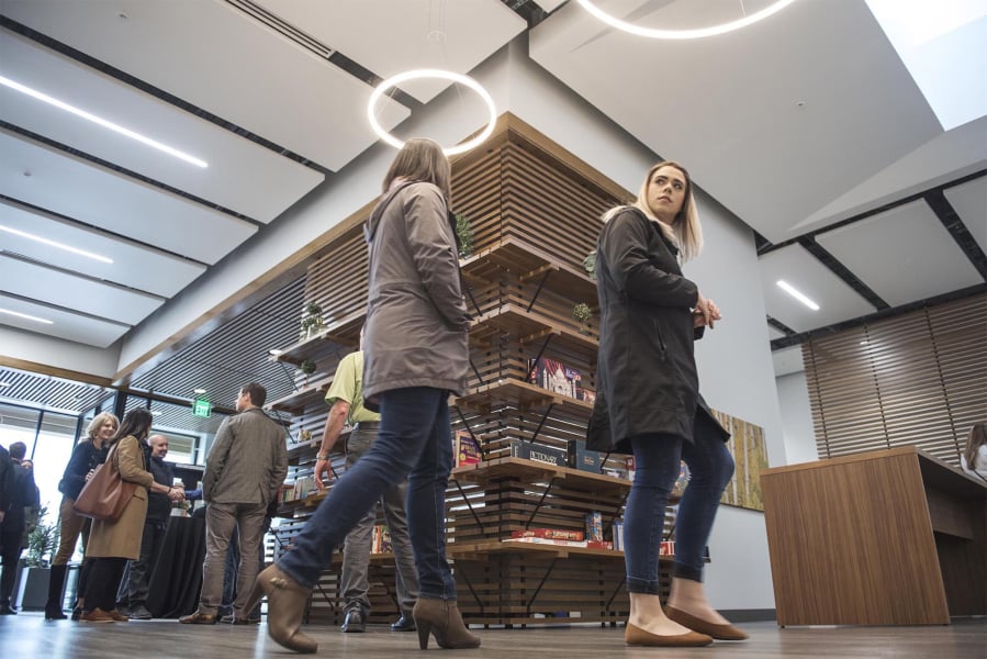 Laura Yoccabel-Dibble, left, and Haylie Huffman, of the Heathman Lodge, explore the new Vancouver Clinic, which has books and board games on shelves. The clinic will provide opportunities for socializing.