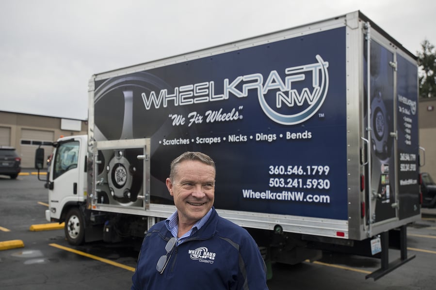 Pat Heffron, owner of WheelKraft NW, stands in front of one of the company’s 10 mobile service trucks that travel to customers and car dealerships for wheel repairs.
